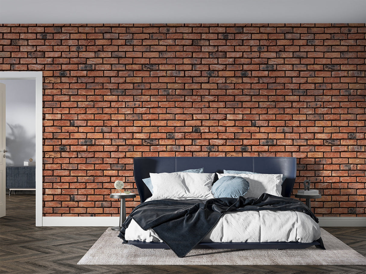 Red brick wall mural in loft-style bedroom showing weathered texture