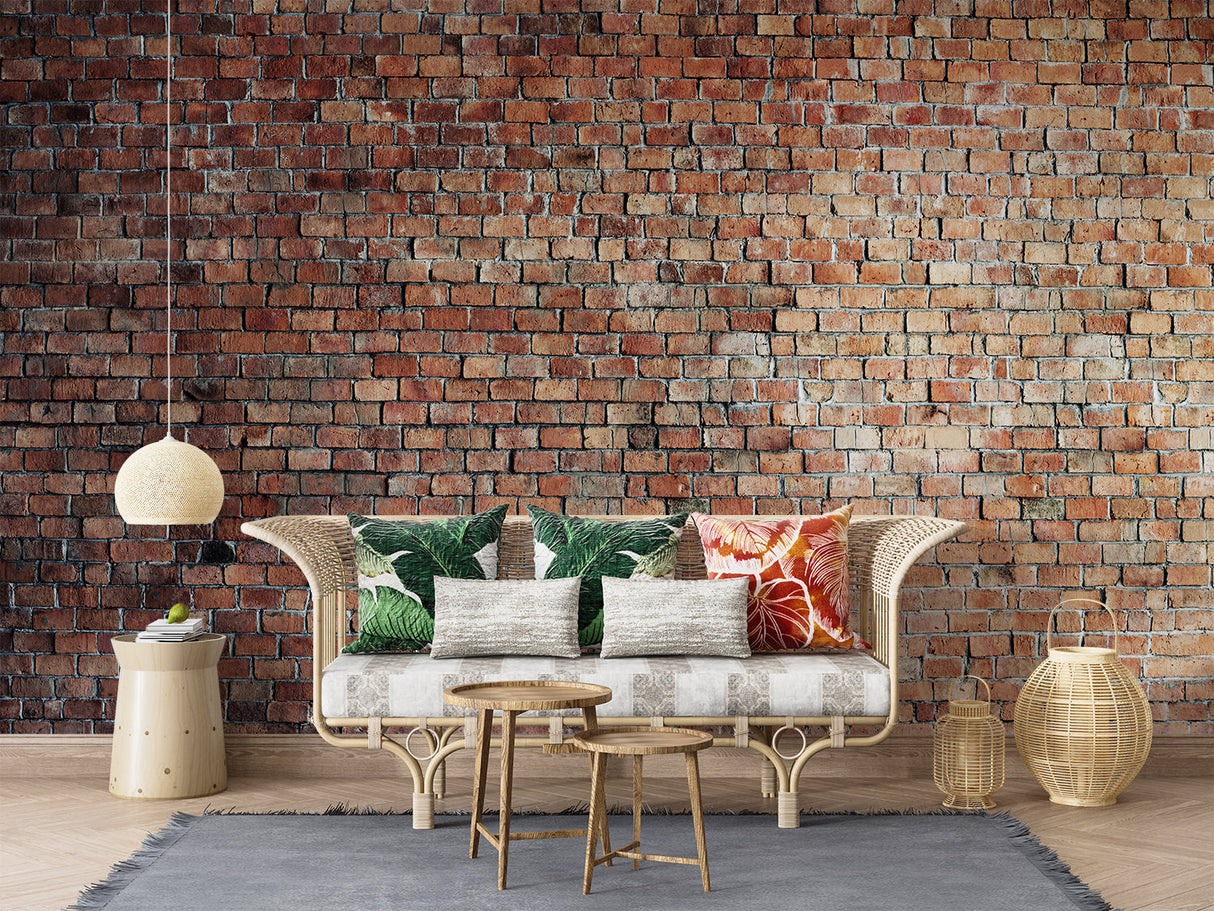Red brick wallpaper mural in modern living room with grey sofa and industrial lighting