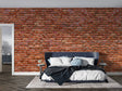 Red brick wallpaper creating industrial charm in modern living room with grey sofa