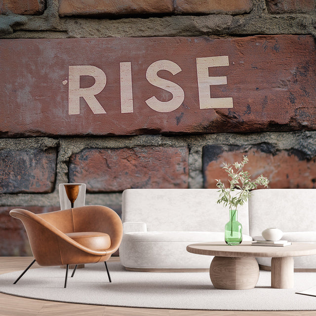 Industrial brick wallpaper with RISE typography shown in modern office space, creating an inspiring accent wall
