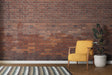 Industrial brick wallpaper creating a cozy atmosphere in modern living room with grey sofa and plants