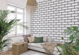 Modern black and white brick wallpaper in a bright contemporary living room with minimalist furniture