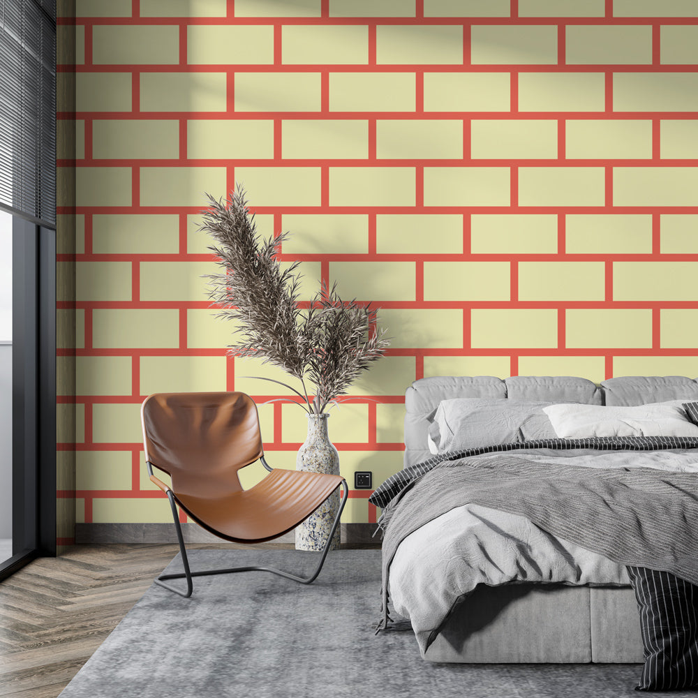 Modern geometric brick wallpaper with yellow and coral tones styled in a bright contemporary living room setting