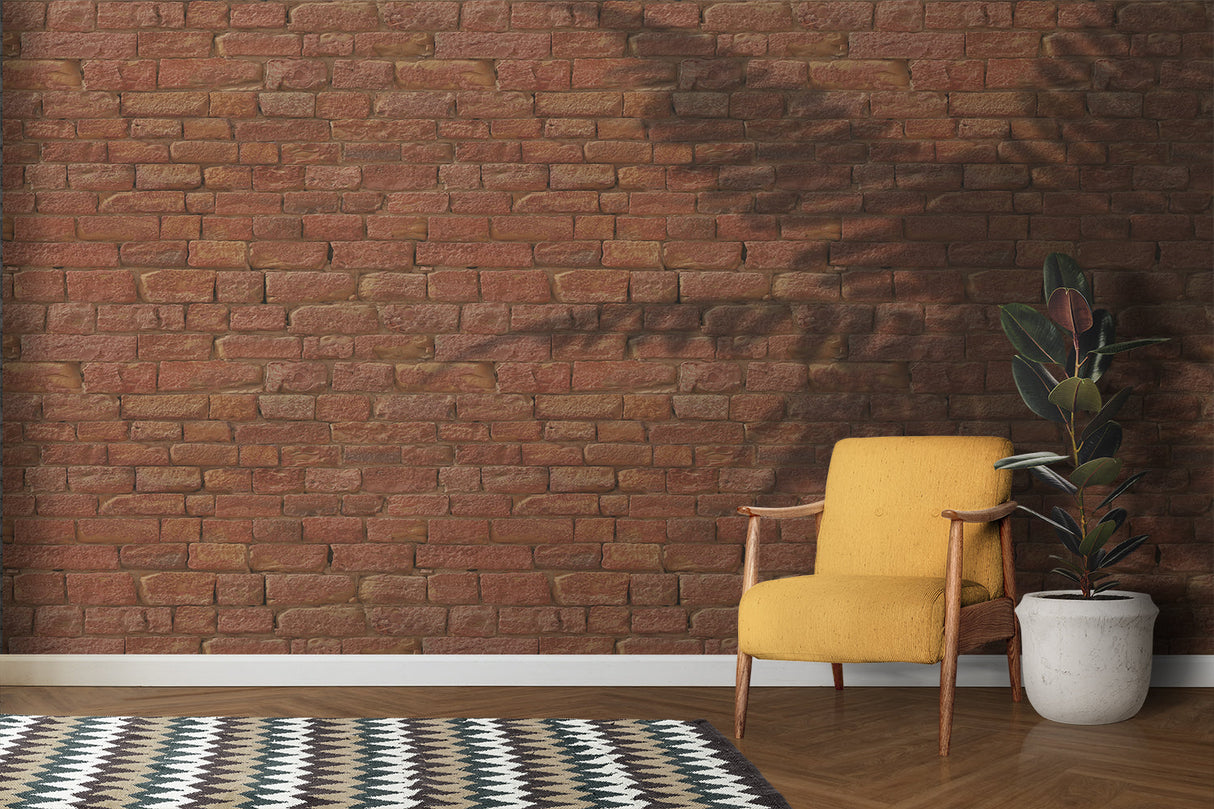 Brick mural wallpaper creating an industrial feel in a modern living room with leather sofa