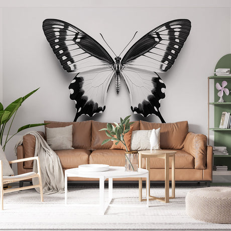 Black and white butterfly wallpaper mural creating drama in a modern living room with minimal furniture