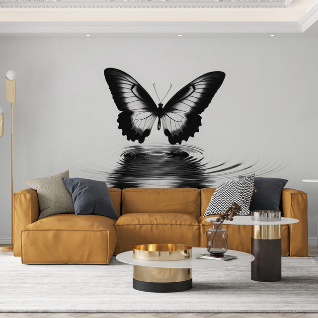 Black and white butterfly wallpaper creating drama in a modern living room with minimalist furniture