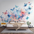 Butterfly wall mural in a bright living room, showing watercolor butterflies in soft blue and pink tones