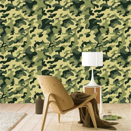 Military green camo wallpaper adding modern edge to a teen bedroom with gaming setup