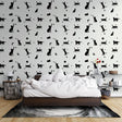 Modern living room with black cat silhouette wallpaper showing cats and moons pattern creating a cozy atmosphere