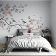 Cherry blossom wallpaper with birds creating a peaceful atmosphere in a bright master bedroom with minimal furniture