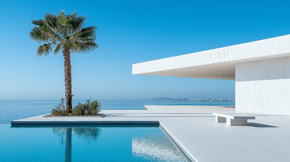 Mediterranean coastal wallpaper displayed in a bright modern living room, showing how the pool scene creates depth