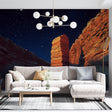 Desert canyon wallpaper creating dramatic atmosphere in modern living room with terracotta accents and mood lighting