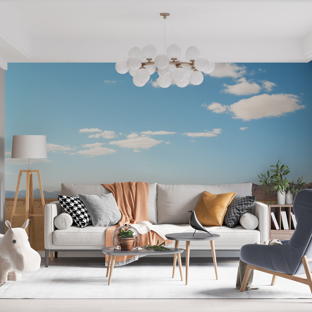 Desert landscape wallpaper creating depth in a modern living room, sunlight highlighting the golden sand dunes and blue sky