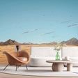 Desert landscape wallpaper creating depth in a modern living room with minimal furniture and natural light