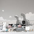 Modern black and white dinosaur mural wallpaper showcased in a bright minimalist children's bedroom with white furniture