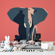 Modern geometric elephant wallpaper in a bright nursery, showing pink and blue tones creating a fresh, artistic atmosphere
