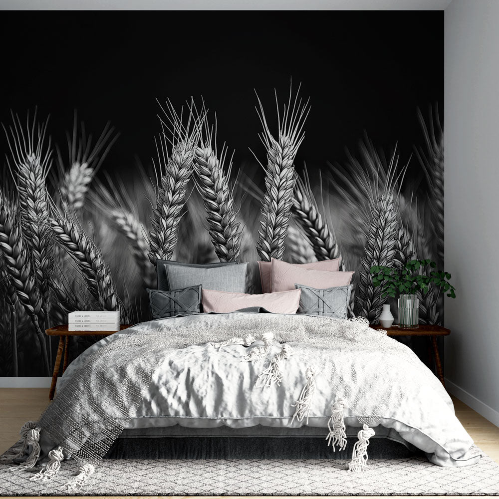 Black and white wheat field wallpaper creating dramatic impact in a modern dining room with minimal furniture