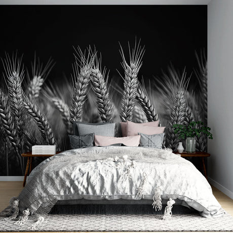 Black and white wheat field wallpaper creating dramatic impact in a modern dining room with minimal furniture