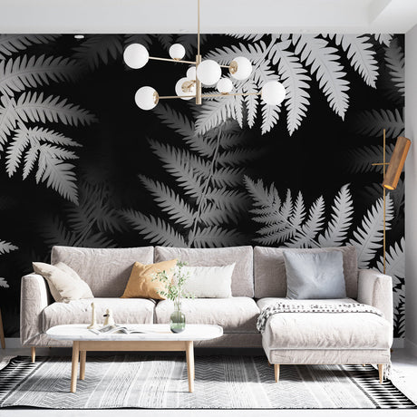 Black and white fern wallpaper creating dramatic impact in a modern living room with minimal furniture