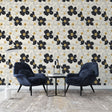 Black and gold floral wallpaper creating elegant atmosphere in modern living room with contemporary furniture