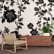 Black and white botanical wallpaper creating a stunning focal point in a modern living room with clean lines and natural light