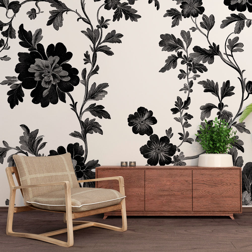 Black and white botanical wallpaper creating a stunning focal point in a modern living room with clean lines and natural light
