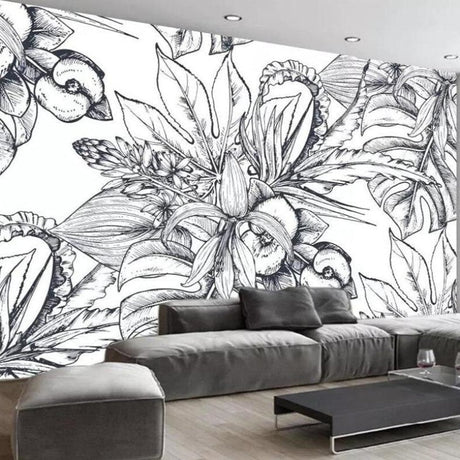 Black and white botanical sketch wallpaper creating drama in a modern living room with minimalist furniture