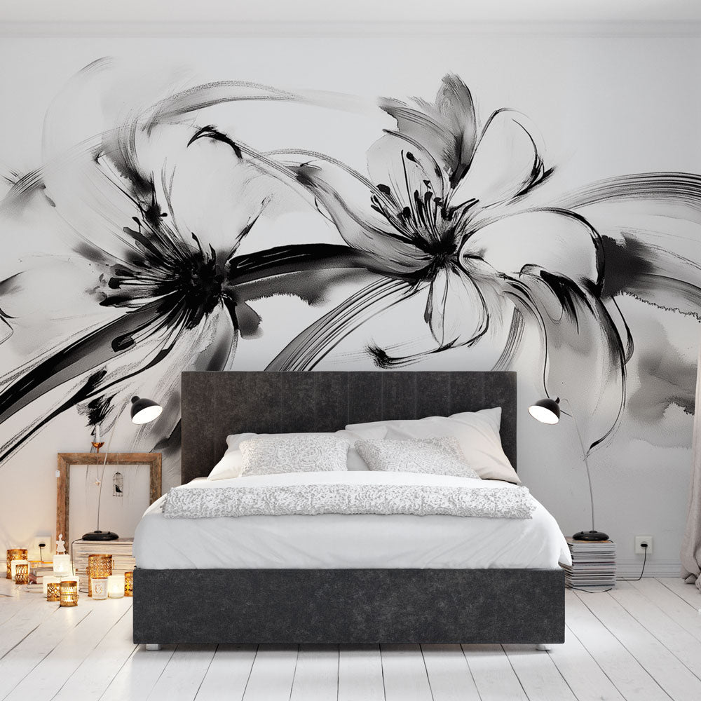 Black and white floral ink art mural wallpaper creating a dramatic statement wall in a modern living room with minimal furniture