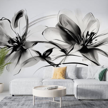 Black and white floral wallpaper mural creating dramatic impact in a modern living room with natural light