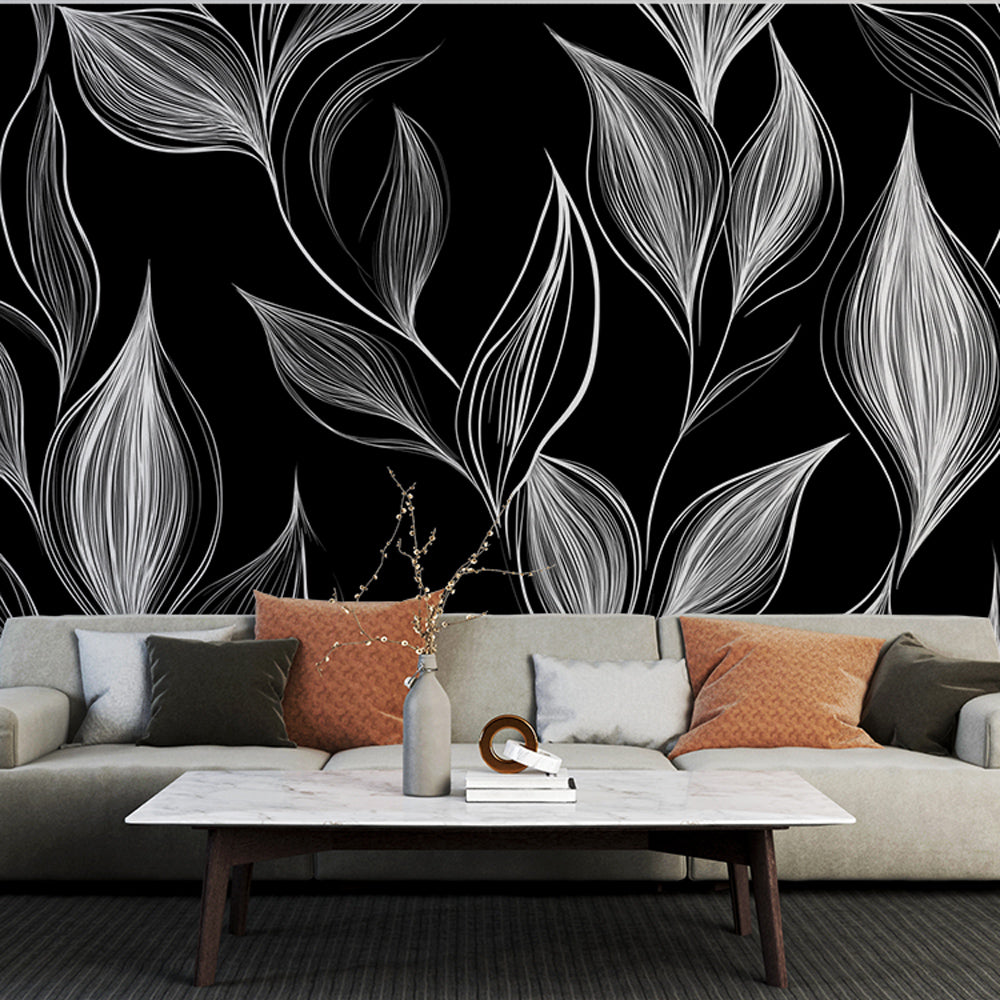Black and white leaf pattern mural wallpaper in a modern dining room creating an elegant botanical backdrop
