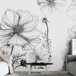 Black and white floral line art wallpaper in modern living room with minimal furniture