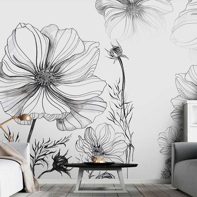 Black and white floral line art wallpaper in modern living room with minimal furniture