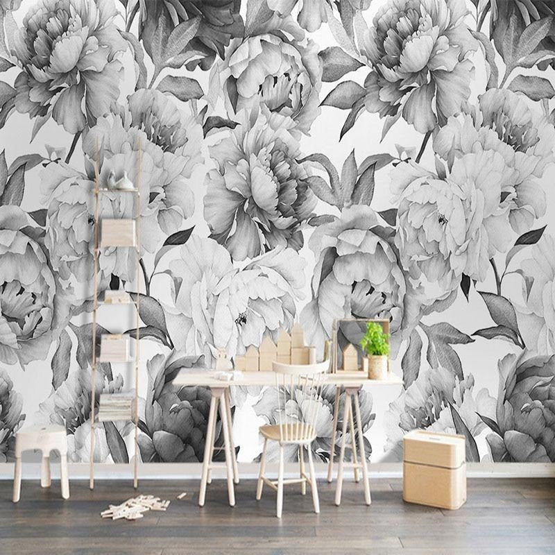 Black and white peony wallpaper in modern living room showing large-scale floral pattern against white furniture