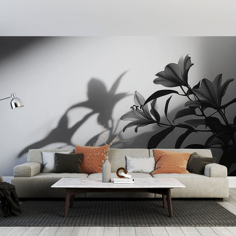 Black and white floral shadow art wallpaper in a modern living room, creating an elegant accent wall with dramatic light effects