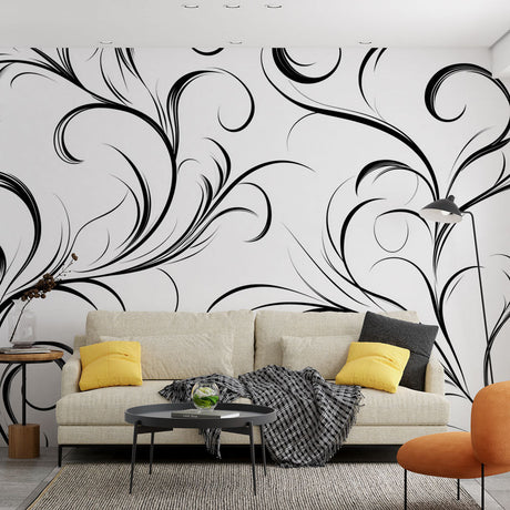 Black and white floral wallpaper creating dramatic impact in a modern living room with minimal furniture