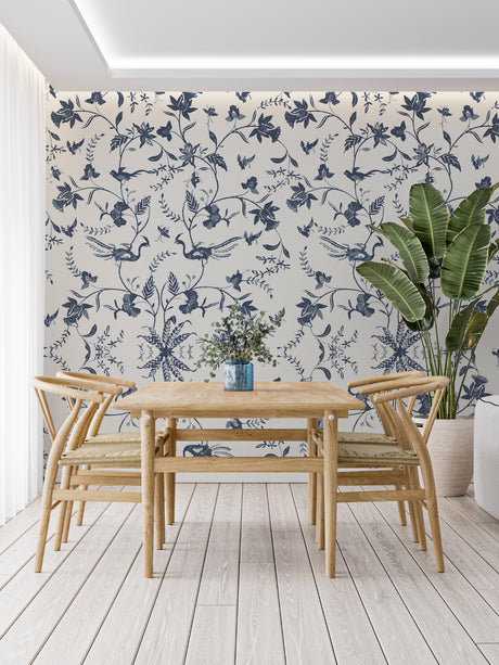 Blue bird floral wallpaper in bright modern living room showing pattern depth and scale