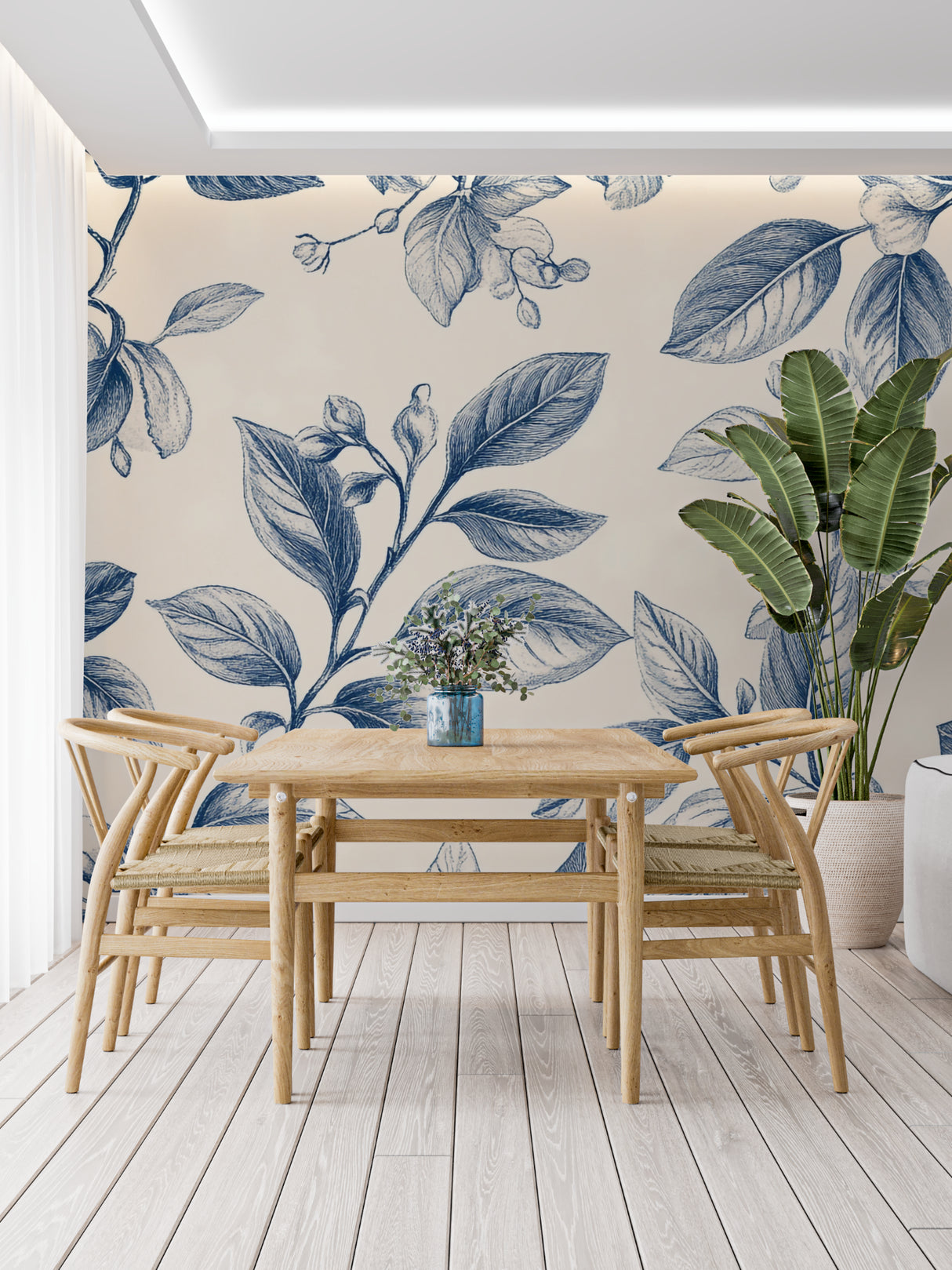 Elegant dining room featuring blue floral wallpaper with classic French furniture