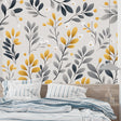 Grey and gold botanical wallpaper in modern living room setting, creating an elegant accent wall