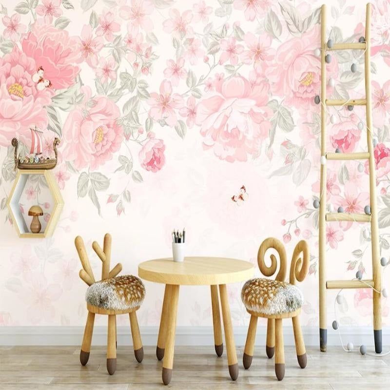 Floral wall mural featuring pink roses and butterflies creating a sweet accent wall in a nursery with white furniture