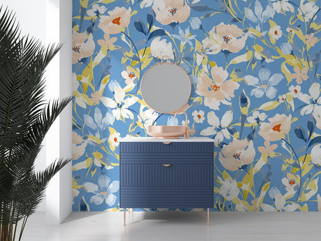 Floral wall mural with watercolor blue and peach blooms in a bright living room setting