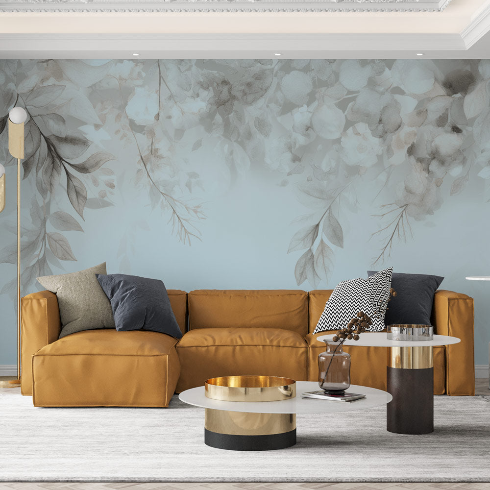 Watercolor leaves wallpaper in blue and grey creating a serene atmosphere in a modern living room setting