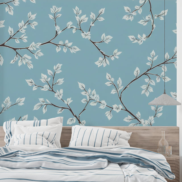 Blue and white botanical wallpaper creating a calm atmosphere in a modern living room setting