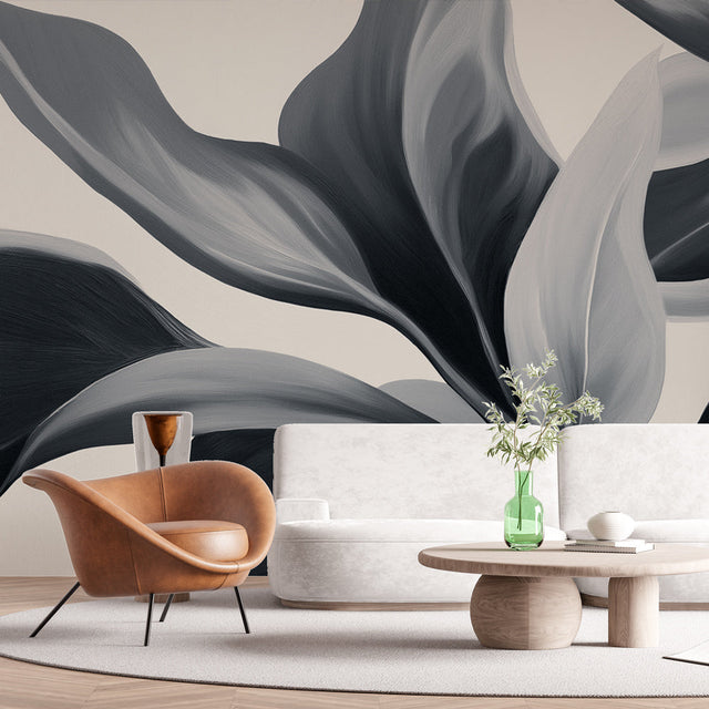 Modern black and grey leaf wallpaper in a minimalist living room creating a sophisticated accent wall