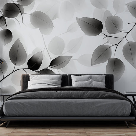 Black and white leaf wallpaper mural creating a serene atmosphere in a modern living room with natural light