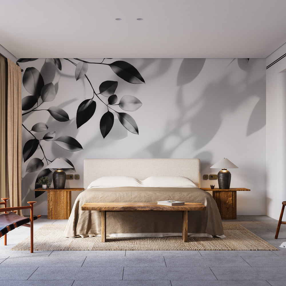 Black and white foliage wallpaper creating a dramatic statement wall in a modern living room with natural light