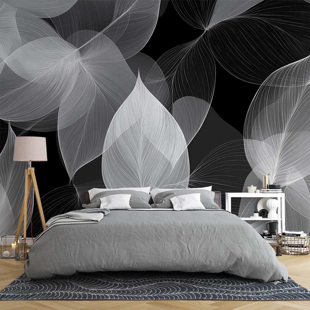 Black and white botanical wallpaper creating a dramatic statement wall in a modern living room with minimalist furniture