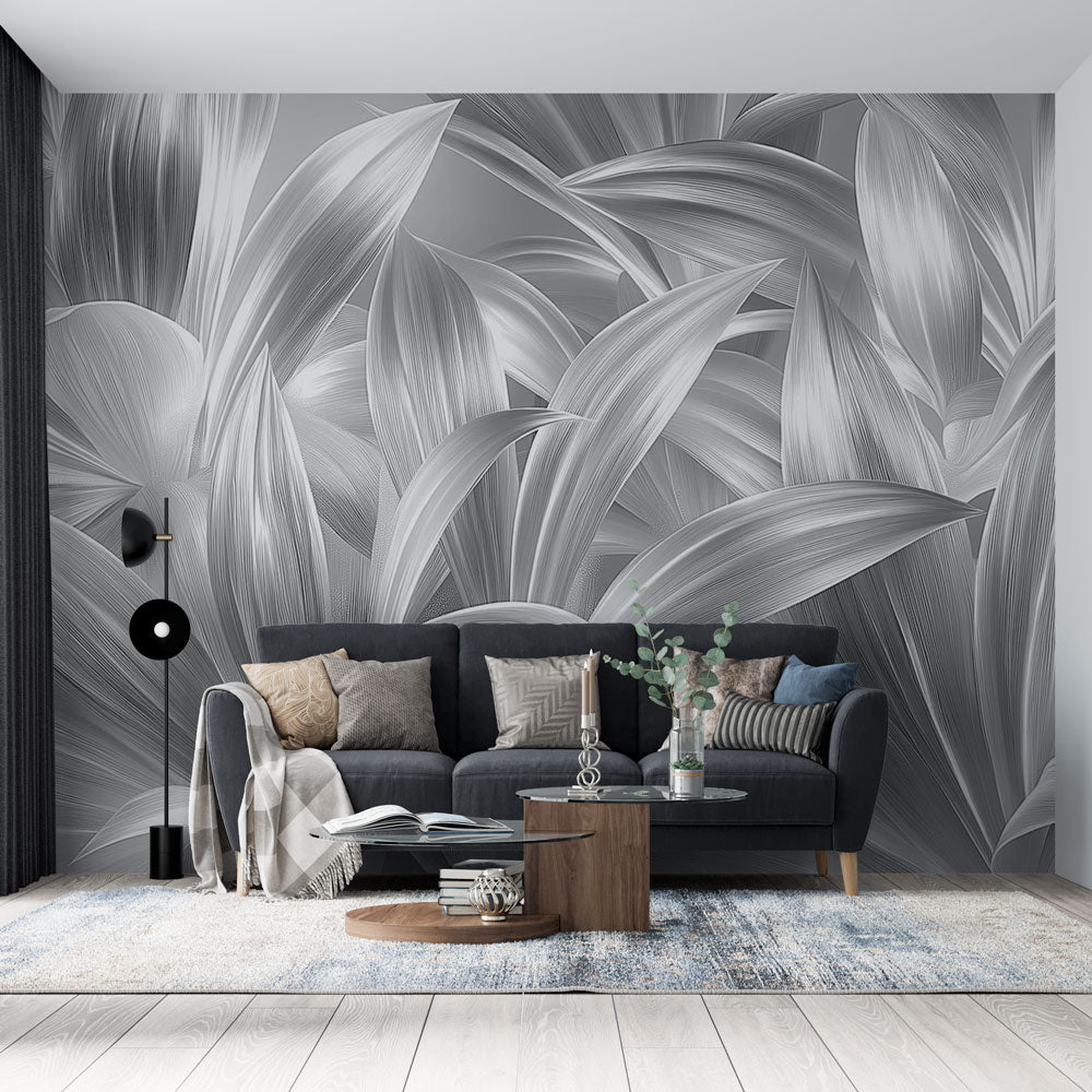 Silver leaf wallpaper mural creating a modern statement wall in a bright, minimalist living room with grey furniture