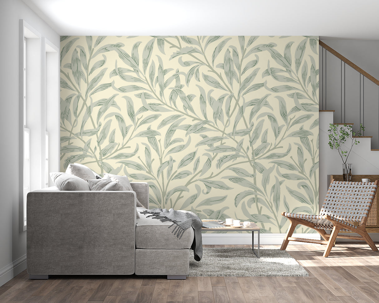 Sage green leaf pattern wallpaper brightening a cozy bedroom space