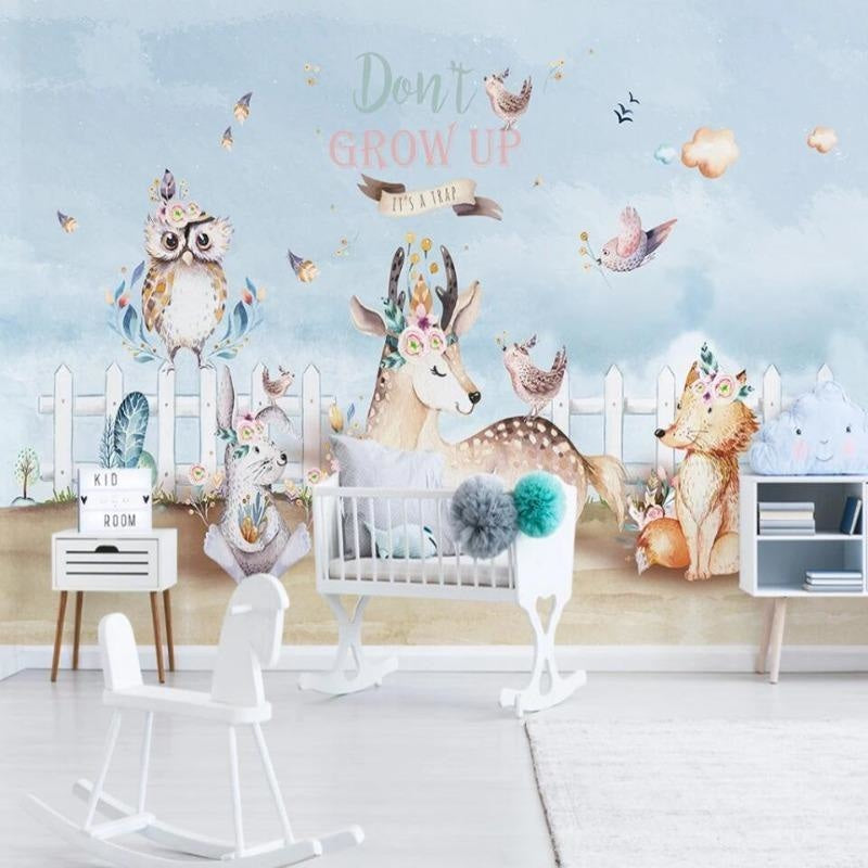 Forest animals wallpaper creating a cozy atmosphere in a modern nursery with mint green walls and natural wood furniture