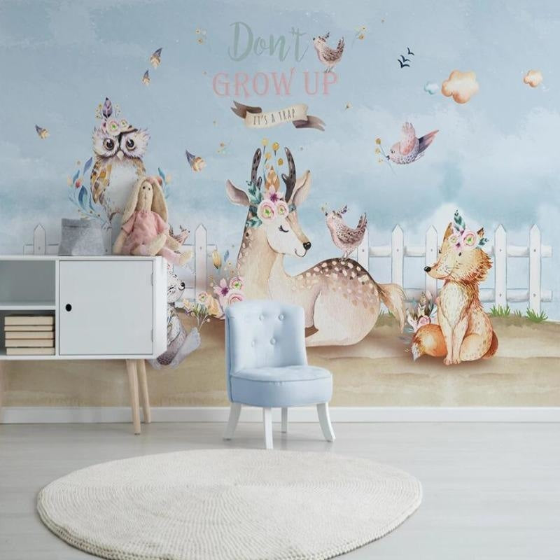 Deer and birch tree wallpaper bringing woodland charm to a child's reading nook with soft lighting